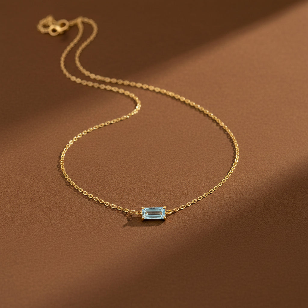 Luxury blue crystal necklace displayed on a premium cream background.