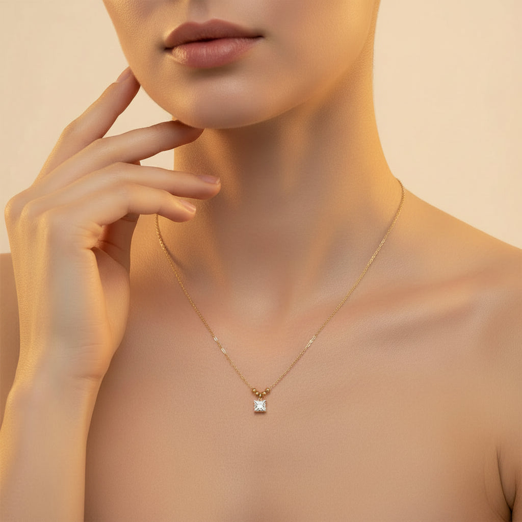 A professional flat-lay catalogue image showing the 18K gold square crystal pendant necklace arranged in a precise circle with soft shadows on a rich cocoa brown background.