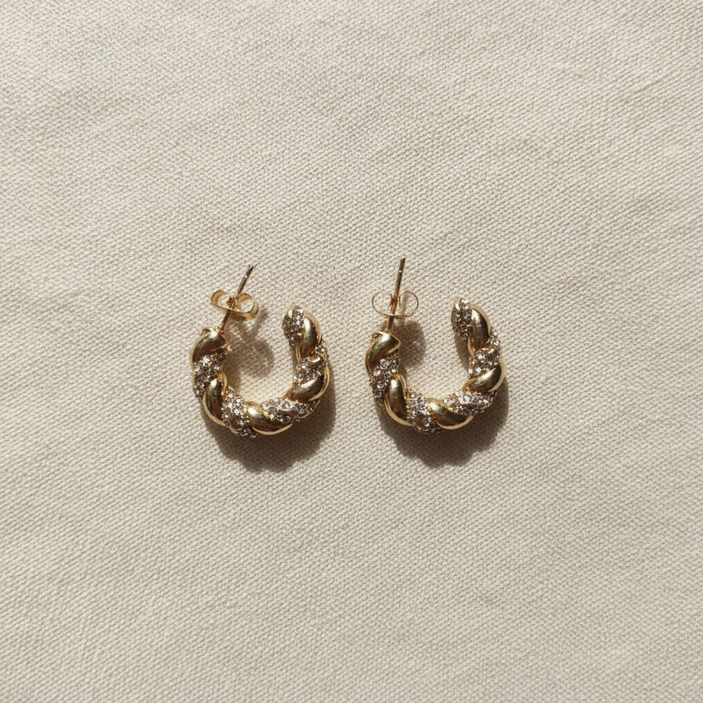 Twisted Crystal Hoop Earrings worn on ear – bold gold crystal hoop earrings for women by Swikaar