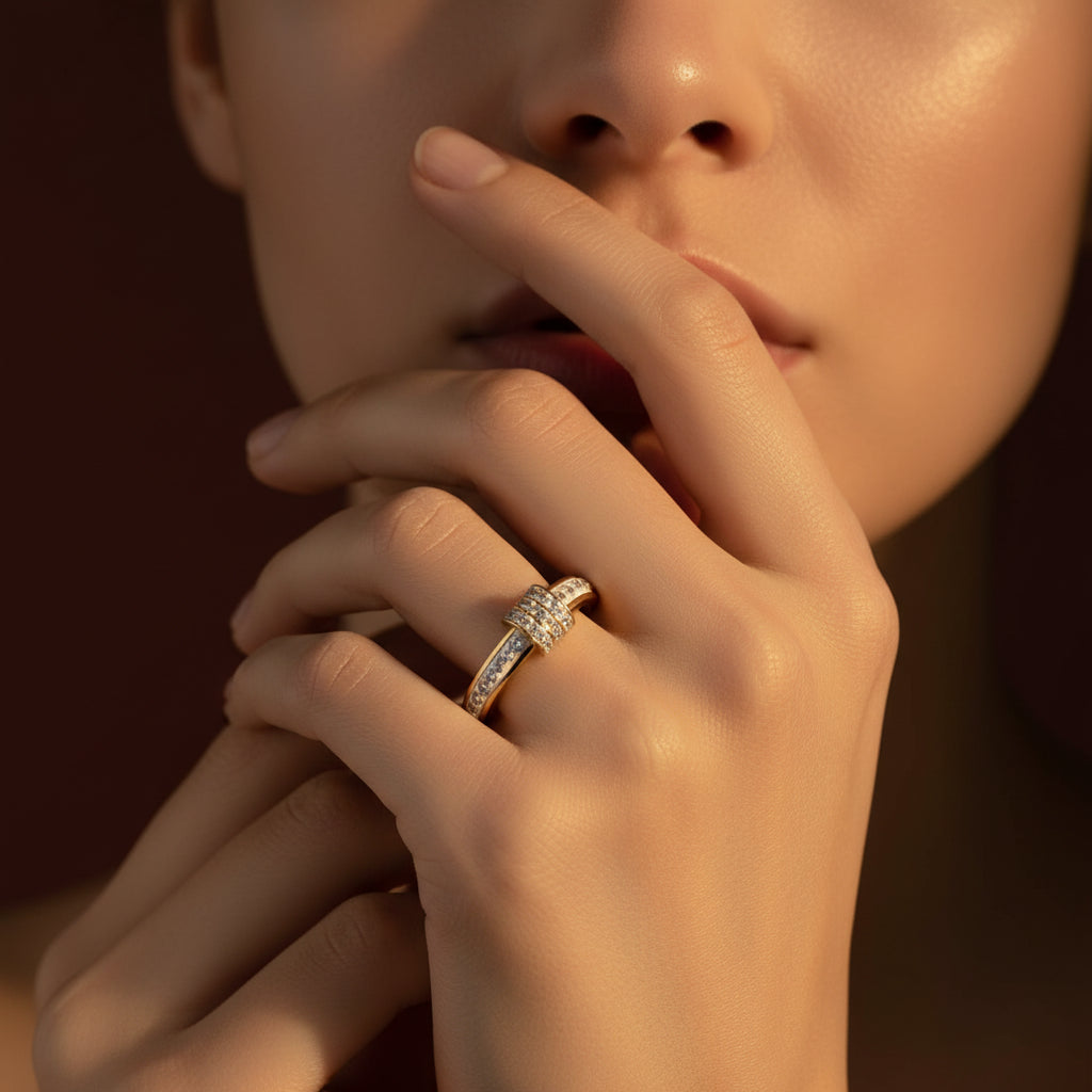 Zoomed-in flat layout of a model with her face half-visible, highlighting the gold white enamel stacker ring on her finger under warm golden lighting against a rich #5b3b3a brown background.